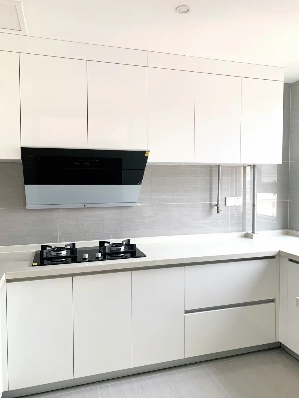 Clean White Kitchen with Grey Tile Backsplash