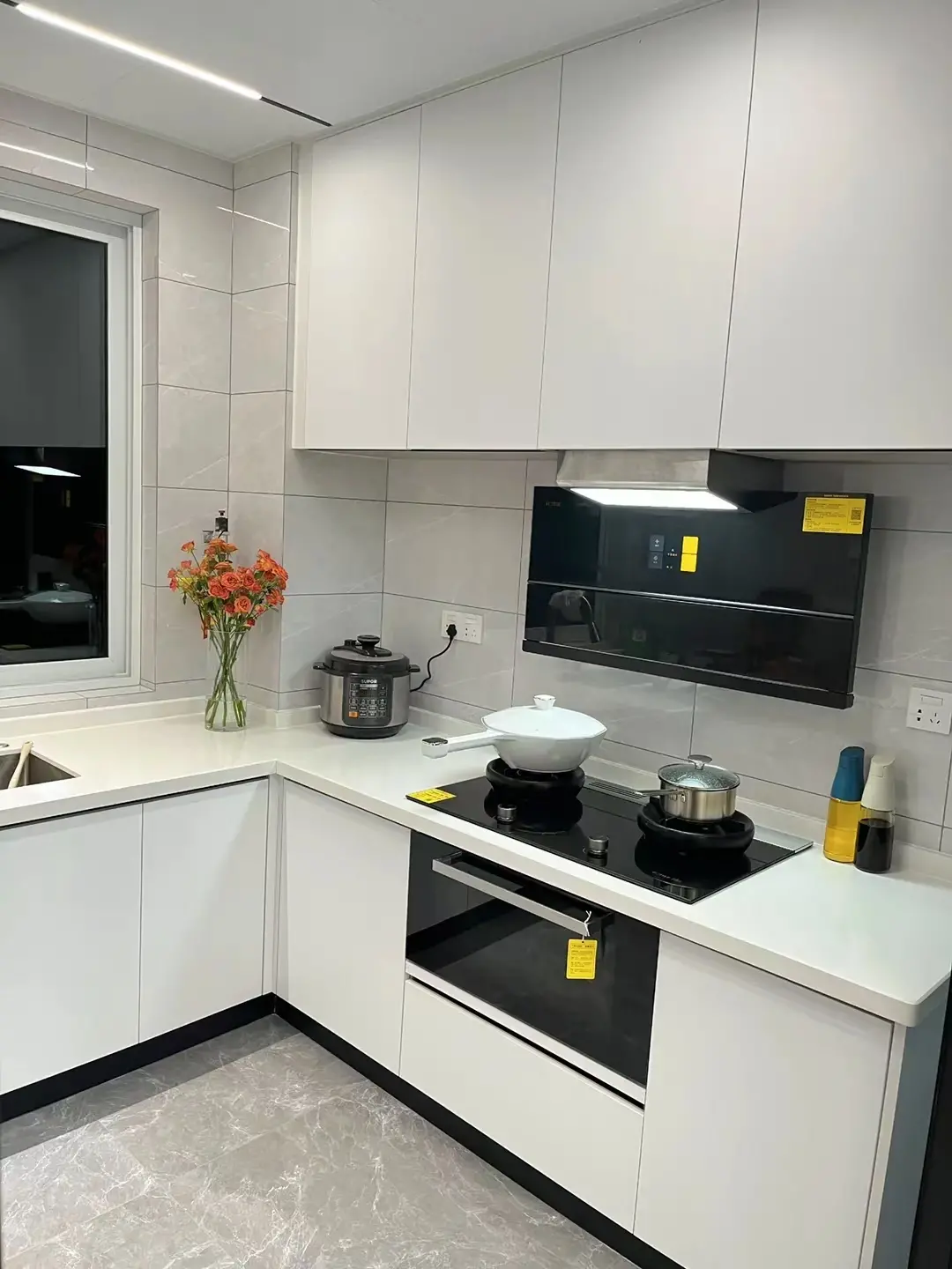 White L-Shaped Kitchen with Under-Cabinet Lighting