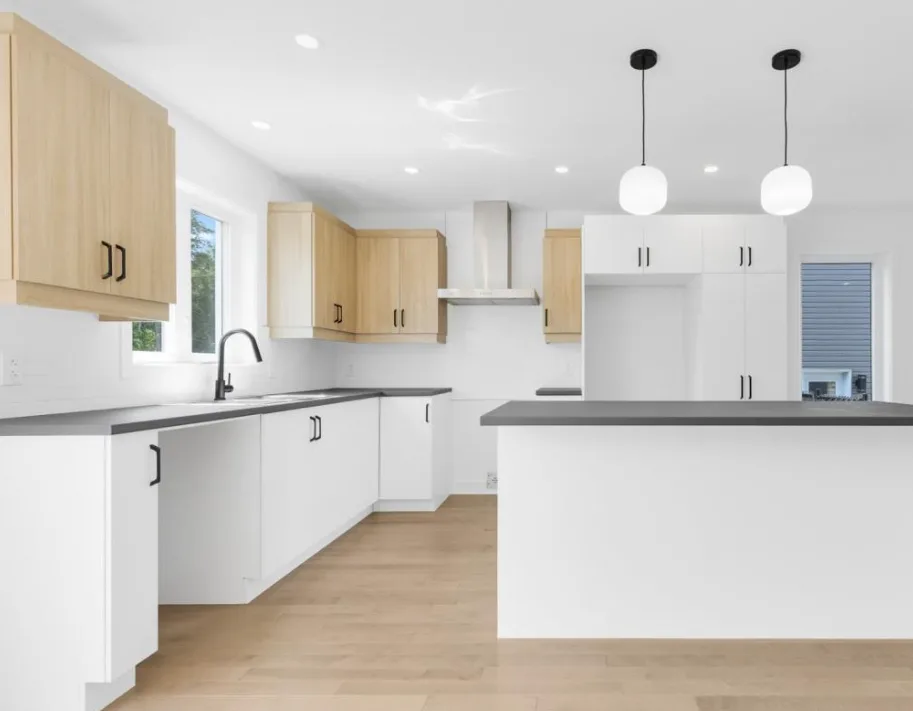 Spacious White and Wood Kitchen with Dark Countertop Island