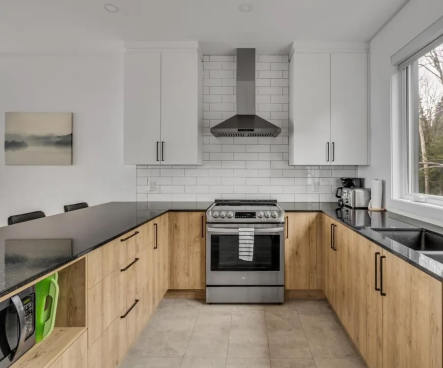 Two-Tone White and Oak Kitchen with Black Countertops